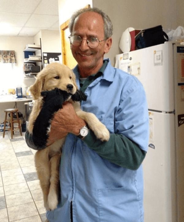 Dr. Goldwasser holding a puppy